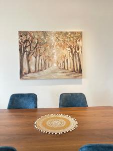 a painting hanging on a wall above a table at Luxury Flat in Casa Finance City in Casablanca