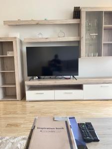 a living room with a large entertainment center with a television at Luxury Flat in Casa Finance City in Casablanca