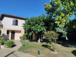 a house with a tree in the yard at L'Atelier Saint-Sulpice - Cocon, piscine, déconnexion entre Bordeaux et St Emilion in Saint-Sulpice-et-Cameyrac