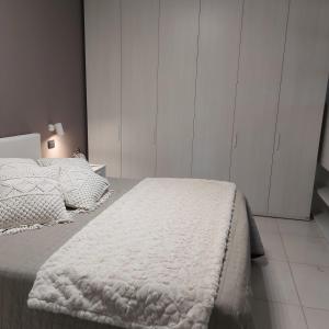 a bedroom with two beds and white cabinets at suite48 in Bari