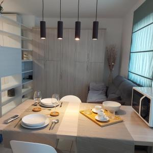 a dining room with a table with plates and wine glasses at suite48 in Bari