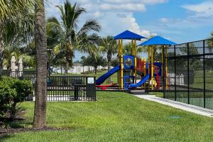 a playground with a slide in a park at Brand New Fort Myers Townhome Community Pool in Fort Myers