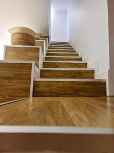a stairway with wooden stairs and wooden floors at Mía Suites I Centro Histórico - PARKING & WIFI FREE in Burgos