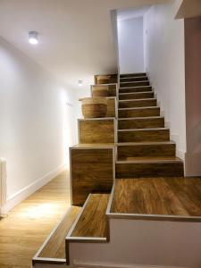 a staircase in a room with wooden flooring at Mía Suites I Centro Histórico - PARKING & WIFI FREE in Burgos