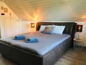 a large bed with two towels on top of it at Csendes Vendégház, Families, Hikers & Bikers in Cserszegtomaj