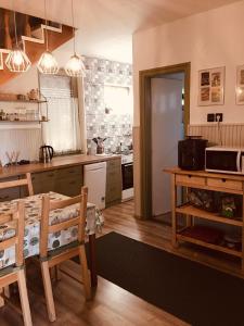 a kitchen with a table and a kitchen with a counter at Csendes Vendégház, Families, Hikers & Bikers in Cserszegtomaj