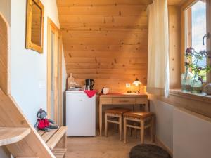 a small kitchen with a refrigerator and a table in a tiny house at Willa Mirwa in Zakopane