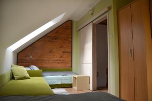 a bedroom with a green couch and a bed at bliźniak-apartamenty in Rowy