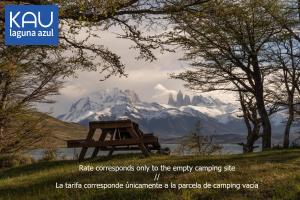 a picture of a snowy mountain with a picnic table at CAMPING KAU LAGUNA AZUL in Torres del Paine