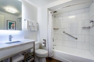 a white bathroom with a sink and a toilet at Holiday Inn - Chicago Dwtn - Wolf Point, an IHG Hotel in Chicago