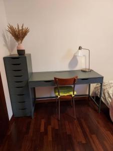 a desk with a chair and a desk with a lamp at Private Room near Treviso "Mira" in Silea