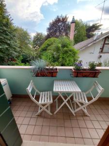 a patio with two chairs and a table and a bench at Private Room near Treviso "Mira" in Silea