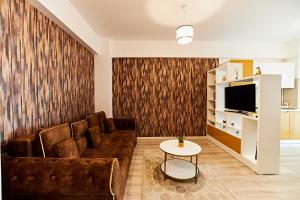 a living room with a couch and a table at CityLife Apartments in Iaşi