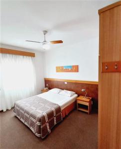 a hotel room with a bed and a window at Union Residence HEER in Novo Hamburgo