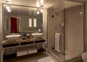 a bathroom with two sinks and a shower at Kimpton Hotel Palomar Los Angeles Beverly Hills, an IHG Hotel in Los Angeles