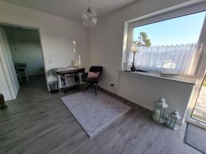 a living room with a window and a chair and a desk at Holiday Apartment Moises y Ruth in Murg +22 photos