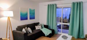 a living room with a couch and a window at Thelighthouse Porto Santo in Porto Santo
