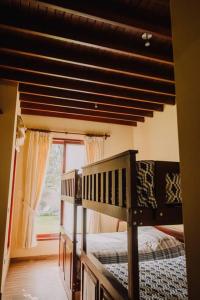 a bedroom with two bunk beds and a window at Casa de Campo en Cieneguilla in Lima