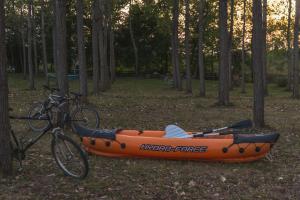 an orange kayak is parked next to a bike at Drina River Glamping in Loznica