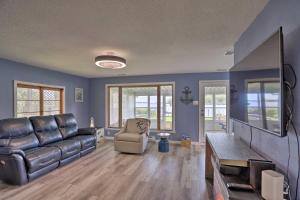 a living room with a couch and a chair at Lake Erie Waterfront Home with Sunroom and Yard! in Erie