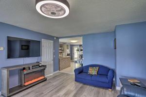 a living room with a couch and a fire place at Lake Erie Waterfront Home with Sunroom and Yard! in Erie