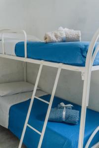two bunk beds in a room with blue sheets at Casa vacanze Montereale in Realmonte