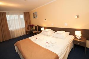 Postel nebo postele na pokoji v ubytování Hotel IKAR