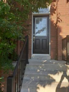 a black door on a brick house with stairs at Adorable Private Suite in Ajax, unique 2 story in Ajax