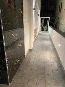 a hallway with black marble walls and a tile floor at IL VIAGGIATORE RELAIS SUL MARE in Gaeta