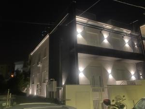 a building with lights on the side of it at night at IL VIAGGIATORE RELAIS SUL MARE in Gaeta