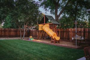 a playground with a slide in a yard at Sacramento Guest House with Patio about 5 Mi to Downtown in Sacramento