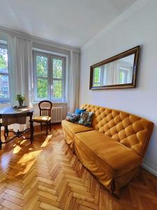 a living room with a large couch and a table at BE IN GDANSK Apartments - IN THE HEART OF THE OLD TOWN - Szeroka 61/63 in Gdańsk