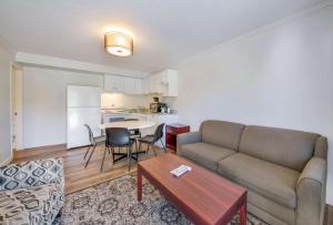 a living room with a couch and a table at SureStay Hotel by Best Western Rossland Red Mountain in Rossland