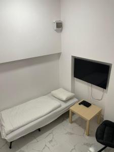 a room with a bed and a tv and a table at Downtown Core Apartments in Budapest