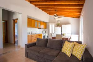 Una sala de estar con un sofá y una cocina. en Villa Hercules, en Kremasti