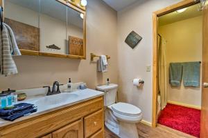 a bathroom with a toilet and a sink and a mirror at Sprawling Mountain-View Cabin 5 Mi to Mesa Verde in Mancos