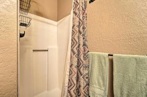 a bathroom with a shower with green towels at Sprawling Mountain-View Cabin 5 Mi to Mesa Verde in Mancos