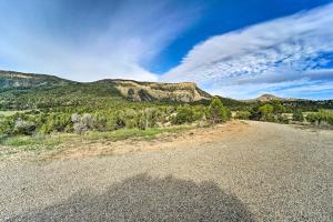 an empty road with mountains in the background at Sprawling Mountain-View Cabin 5 Mi to Mesa Verde in Mancos