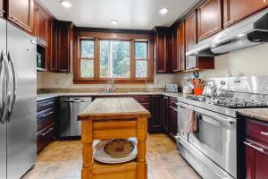 a kitchen with wooden cabinets and stainless steel appliances at Antler River Lodge in Guerneville