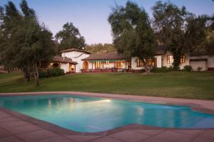 a swimming pool in the yard of a house at Hotel Viña Kankura in Palmilla