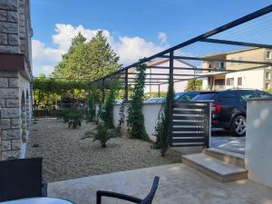 a pergola with plants on it in a yard at Apartment Selce 2379a in Selce