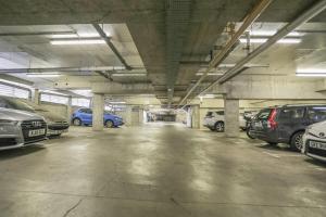 a parking lot with cars parked in a parking garage at Diamond Apartment in Belfast