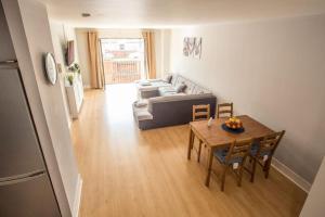 a living room with a table and a couch at Diamond Apartment in Belfast