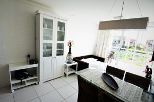 a kitchen with a table and a large window at BEACH PARK PALM - COBERTURA Luxo in Aquiraz