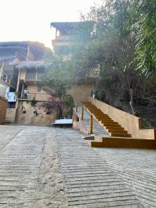 a group of stairs and a building with trees at Cabaña DREAM HOUSE in San Agustinillo +5 photos
