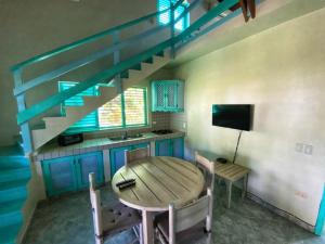 a dining room with a table and a staircase at Villa 20 in Las Terrenas
