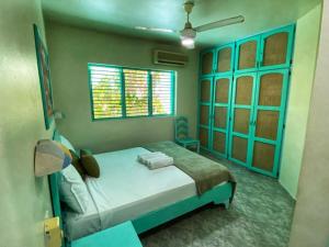 a bedroom with a bed and a window at Villa 20 in Las Terrenas