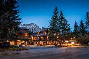 a large building with a mountain in the background at Charltons Banff in Banff