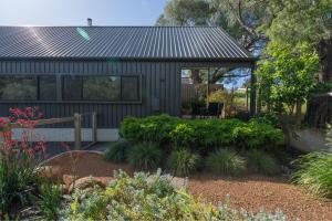 a garden with a house with a gazebo at Margaret River Bungalow-3-forest - pet friendly in Margaret River Town