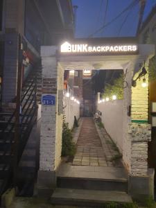 an entrance to a building with a sign that reads sunlight backpackbreakers at Bunk Backpackers Guesthouse in Seoul